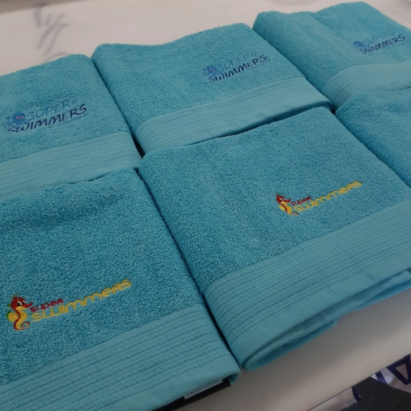 Two embroidered logo designs split equally over 80 varying coloured towels for a swimming school in both Dinnington and Rossington. www.superswimmers.co.uk